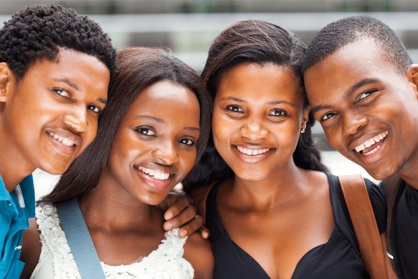 Four friends smiling warmly at the camera